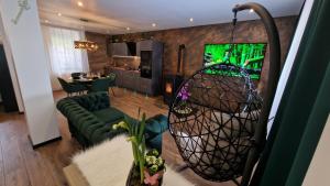 a living room with a television and a living room with a couch at Ferienhaus Mefady Jünkerath in Jünkerath