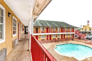 a view from the balcony of a building with a pool at OYO Hotel San Antonio Lackland near Seaworld in San Antonio