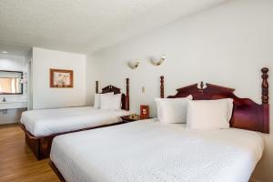 Postel nebo postele na pokoji v ubytování OYO Hotel Groesbeck