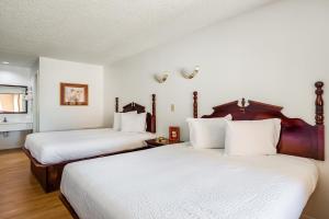 Postel nebo postele na pokoji v ubytování OYO Hotel Groesbeck