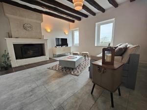 a living room with a couch and a fireplace at Le Logis, Villa Beaulieu in Saumur