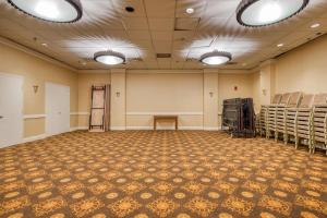 an empty room with chairs and a table in a room at Gardentree Hotels Memphis East near I 40 in Memphis