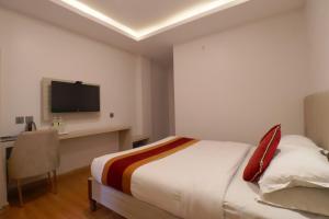 Postel nebo postele na pokoji v ubytování Capital O Palagya Hotel Pvt Ltd