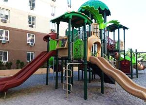 a playground with several slides and a slide at Timbi Suites Mactan in Lapu Lapu City