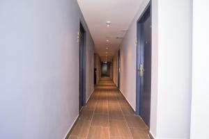 a hallway with blue doors and a long corridor at Hotel O Gs Hotels Near Strand Mall in Kota Damansara