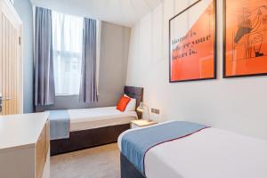 Postel nebo postele na pokoji v ubytování Townhouse Apollo, Hyde Park