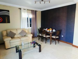 a living room with a couch and a table at Casa Tito in Playa Honda