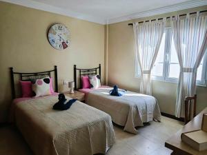 En eller flere senge i et værelse på Casa Tito