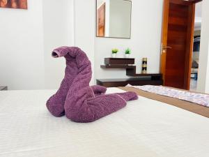 En eller flere senge i et værelse på Casa Tito