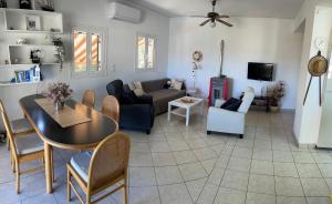 a living room with a table and a couch at Villa Mike's House in Apolpaina