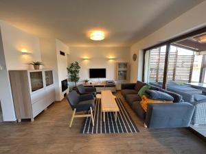 a living room with a couch and a table at Lake house 630 in Šajdíkove Humence +3 photos