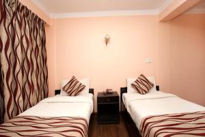 Letto o letti in una camera di Kathmandu City Hotel