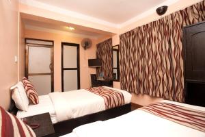 Letto o letti in una camera di Kathmandu City Hotel