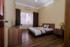 Postel nebo postele na pokoji v ubytování BIDV Central Da Lat Hotel