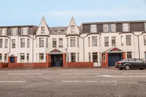 a large building with a car parked in front of it at Cardiff Riverside Hotel by Belvilla in Cardiff