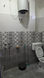 a bathroom with a toilet and a sink at Nivaara in Bīr +20 photos