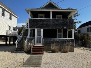a house with a staircase leading to the front door at Bay Views! Wifi Bay Side Duplex In Ship Bottom in Ship Bottom