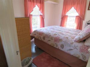 a bedroom with a bed and two windows at Bay Views! Wifi Bay Side Duplex In Ship Bottom in Ship Bottom
