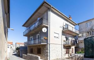 a building with two balconies on the side of it at Awesome Apartment In Novi Vinodolski in Novi Vinodolski