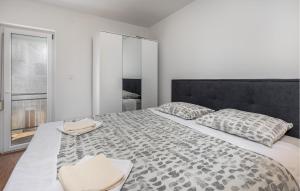 a bedroom with a large bed with two pillows at Awesome Apartment In Novi Vinodolski in Novi Vinodolski