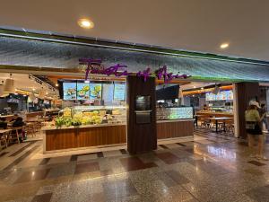 a food court in a shopping mall with people eating at The Marvelous Suites at Times Square Kuala Lumpur in Kuala Lumpur