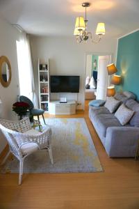 a living room with a couch and a tv at Apartment Kaiserperle mit Balkon direkt am Strand in Lübeck