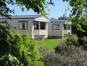 a house with a garden in front of it at Findhorn Bay - Mobile Holiday Homes in Findhorn