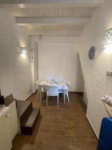 a dining room with a white table and chairs at Dreaming Cefalù in Cefalù