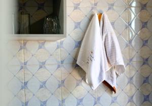 a bathroom with two towels hanging on a wall at Mwanza city escape in Mwanza +25 photos