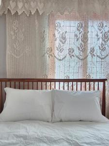 a bed with a wooden head board and a window at Live in Busan Stay Gwangalli in Busan