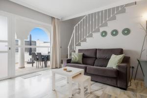 a living room with a couch and a staircase at Casa Marbella Vime Resort Gym Spa Pools in Marbella