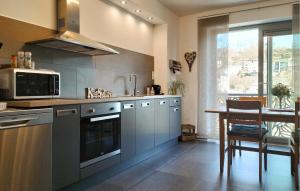 a kitchen with stainless steel appliances and a table at Beautiful Apartment In Bouillon in Bouillon
