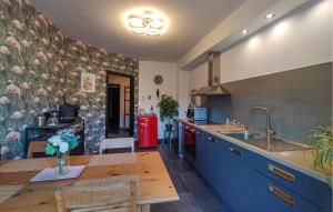 a kitchen with a table and a sink and a counter at Beautiful Apartment In Bouillon in Bouillon