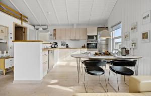 a kitchen with a table and some chairs in it at 3 Bedroom Nice Home In Otterup in Otterup