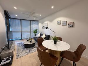 a living room with a table and a couch at Luxury 1B Aprt in BNE City Land mark Queens Wharf in Brisbane