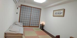 a room with a bed and a sliding door at Kyoto Guesthouse Rantan - Vacation STAY 84810v in Nishi-kujō-Toriiguchichō
