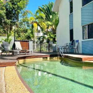 a swimming pool in the middle of a house at Beach Comber in Port Douglas