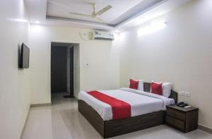 a bedroom with a bed and a ceiling fan at Hotel shivalaya in Haldwāni
