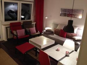 a living room with a couch and a table at HertenFlats - Apartment Balkon in Herten