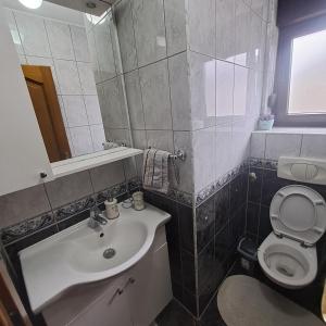 a bathroom with a sink and a toilet at Villa Behić in Bihać +46 photos