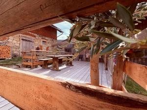 a wooden deck with a picnic table on it at Zum oidn Schmie Haus in Pemfling