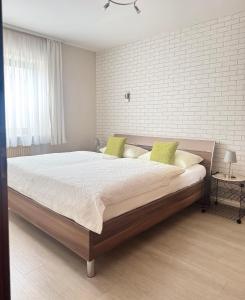 a bedroom with a large bed with green pillows at Apartments Gala, ruhige Lage, stadtnah in Bad Kissingen +63 photos