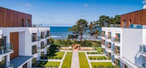 an aerial view of the ocean between two buildings at SunSet Let`s Sea Baltic Spa in Gąski