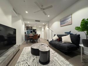 a living room with a couch and a table at 2B2B Retreat Land mark in Brisbane city Queens wharf in Brisbane
