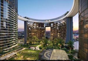 a view of a building with palm trees and buildings at 2B2B Retreat Land mark in Brisbane city Queens wharf in Brisbane