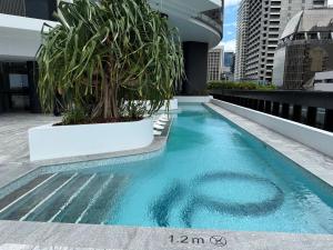 a pool on the roof of a building with a plant at 2B2B Retreat Land mark in Brisbane city Queens wharf in Brisbane