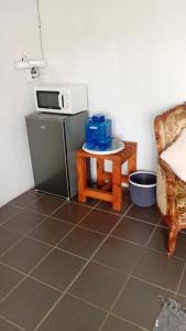 a kitchen with a small table and a microwave at LARA'S PLACE in Volksrust