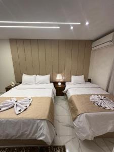 A bed or beds in a room at Inside Pyramids Hotel