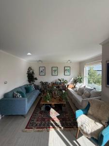a living room with two couches and a coffee table at Cómoda Habitación Punta Arenas in Punta Arenas +2 photos