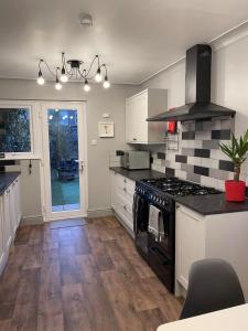 a kitchen with a stove and a counter top at Beautiful 3 bedroom house close to Lowestofts south beach in Lowestoft